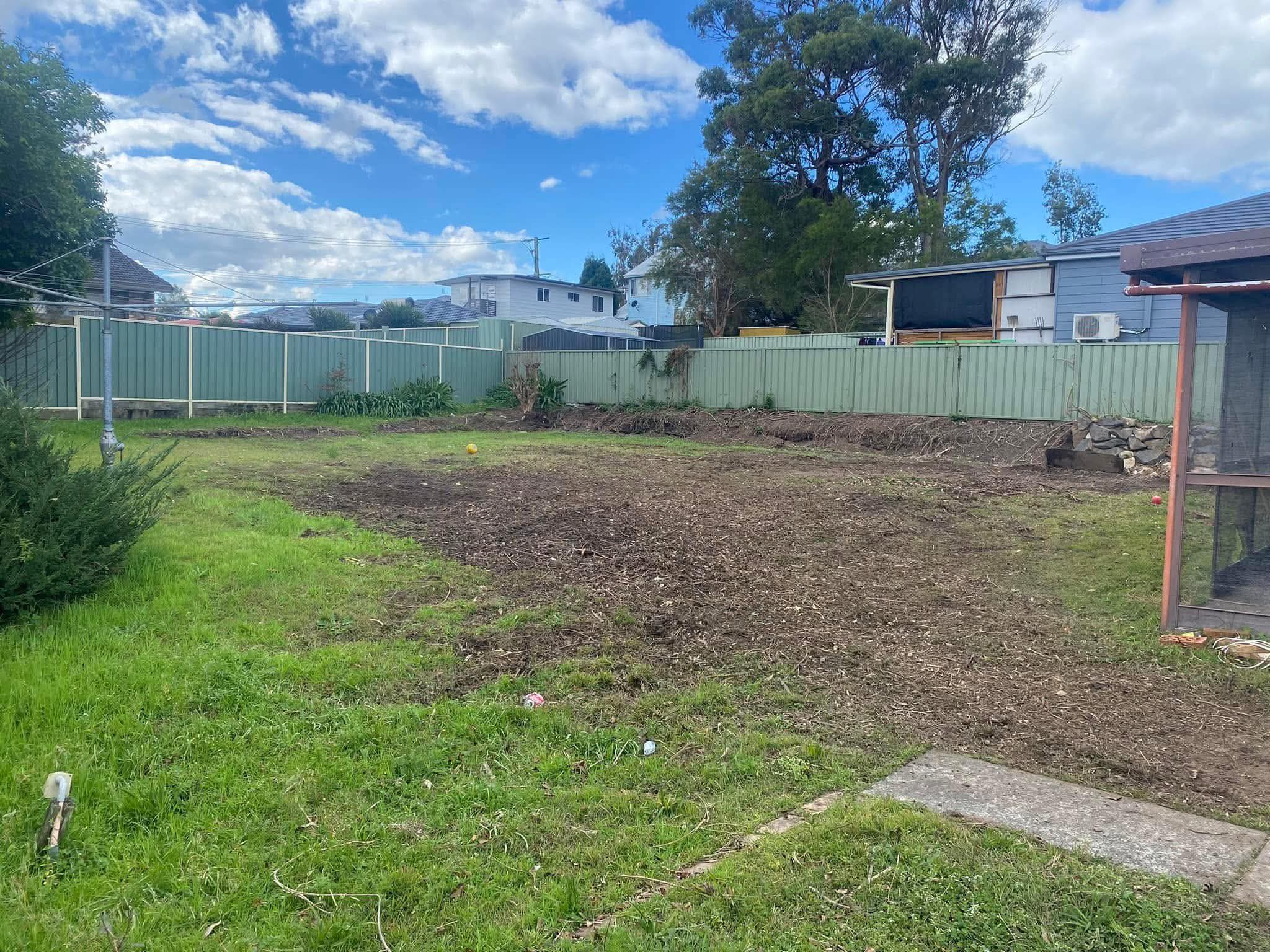 The same yard after clean-up, cleared and ready for a fresh lawn